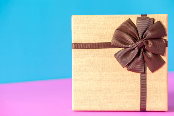 istock Close-Up Of Wrapped Gift Against Colored Background 1058409898