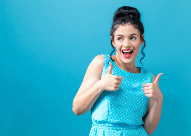 istock Young woman giving thumbs up 1058410032