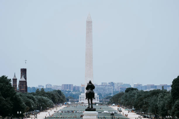 istock Statue Against Washington Monument In City Against Sky 1058420716