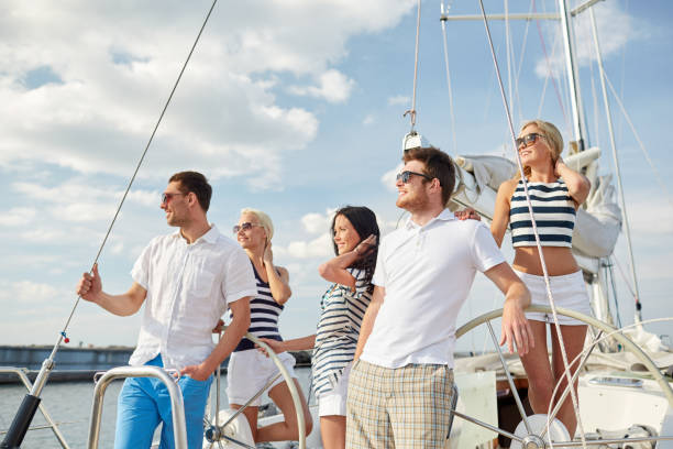 istock smiling friends sailing on yacht 1058425622