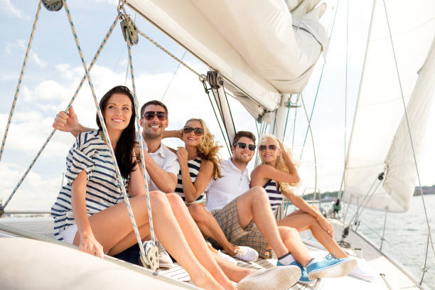 istock smiling friends sitting on yacht deck 1058426744