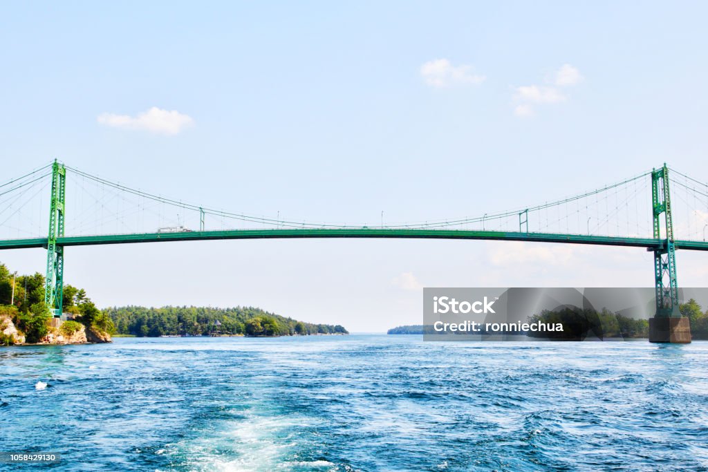 Thousand Islands International Bridge Over Saint Lawrence River Constructed in 1937, the Thousand Islands International Bridge spans over the St. Lawrence River connecting New York, USA, with Ontario, Canada in the middle of the 1000 Islands region. Island Stock Photo