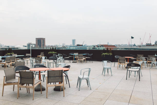 istock Empty Chairs And Tables At Outdoor Cafe In City 1058431172
