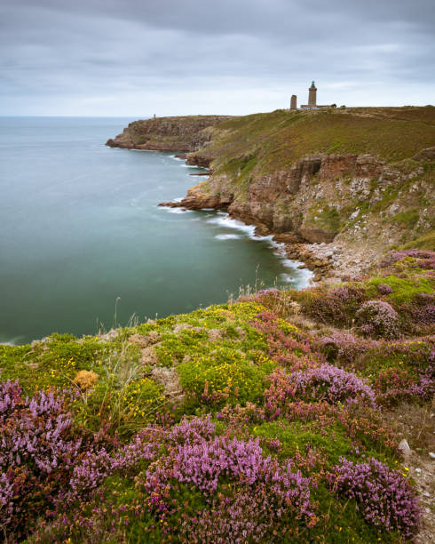 istock Spectacular cliffs in Cap Frehel with lighthouse on a cloudy day in summer 1058435060