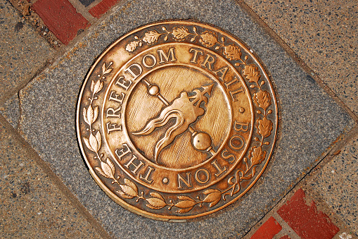 Boston, MA, USA August 10, 2011 A circular marker directs tourists to the attractions along the Freedom Trail in Boston