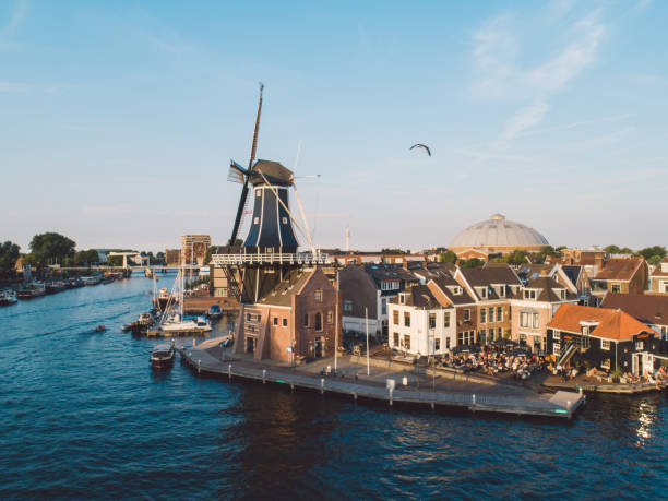 high angle view of river by buildings in town against sky - haarlem stockfoto's en -beelden