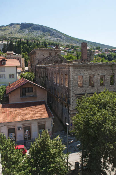 Bosnia: a palace bombed during the Bosnian War (1992-1995) in the streets of Mostar Mostar, Bosnia and Herzegovina, Europe - July 5, 2018: a palace bombed during the Bosnian War (1992-1995) in the streets of Mostar, the old city named after the bridge keepers (mostari) who in the medieval times guarded the Stari Most (Old Bridge) ethnic cleansing stock pictures, royalty-free photos & images