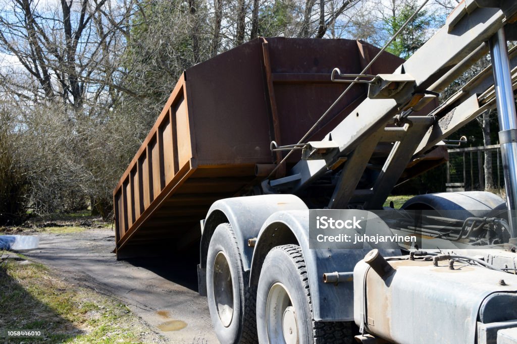 Truck roll-off dumpster Truck roll-off dumpster. Industrial Garbage Bin Stock Photo