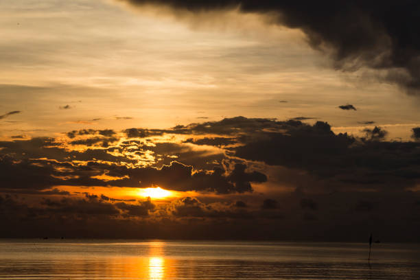 Black rain is blocking sunrise in the sea. The dawn of a bright new morning.