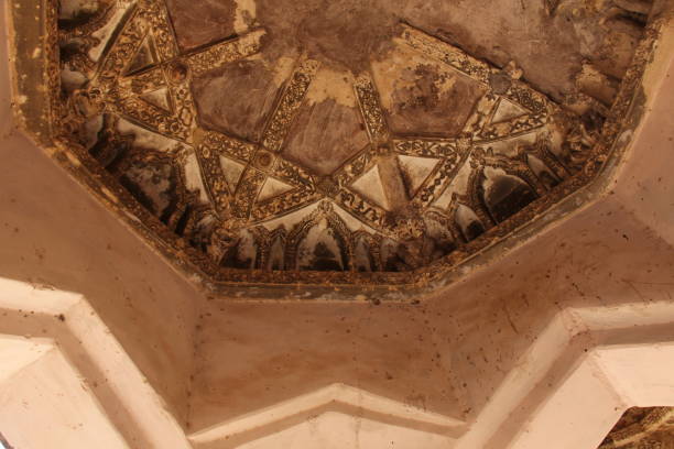 istock Queen baths in Hampi, Karnataka state, India. Carving stone ancient background. Unesco World Heritage Site. Geometric carved patterns on the ceiling 1058447000