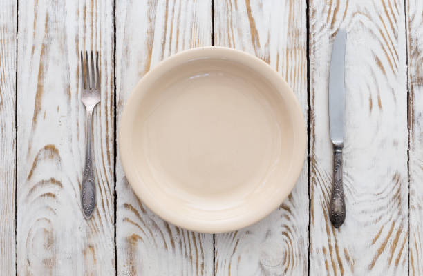 istock cutlery on wooden table 1058452970