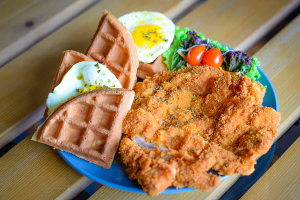 istock Chicken cutlet Waffle with Sunny Side Up Egg and salad 1058454548