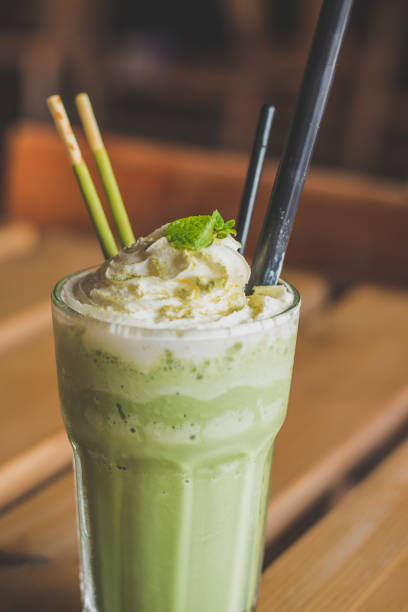 istock matcha blended latte with whipped cream mint leaves chocolate sticks 1058454652