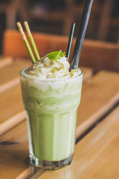 istock matcha blended latte with whipped cream mint leaves chocolate sticks 1058454712