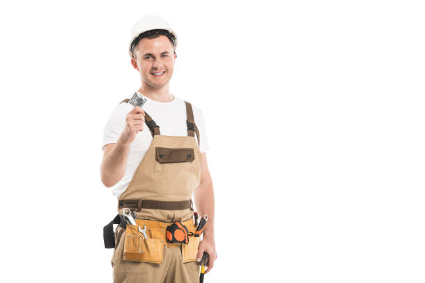 istock handsome adult builder holding condom and looking at camera isolated on white 1058460892