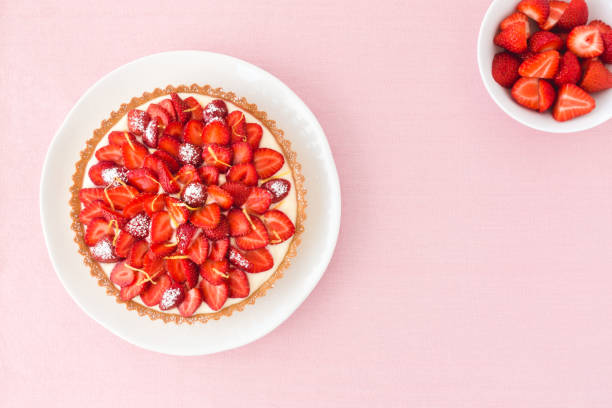 istock Strawberry Cake and Strawberries in a Bowl on Pink 1058465618