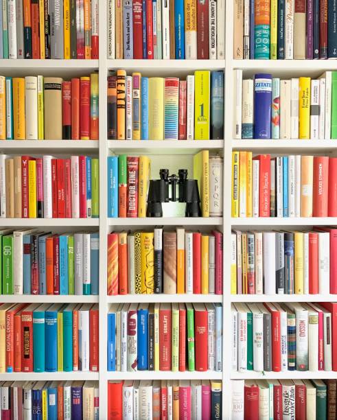 istock Library shelves and one part filled with black binoculars 1058467898