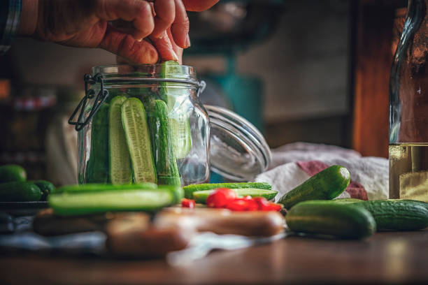 preserving organic cucumbers in jars - pickle relish imagens e fotografias de stock