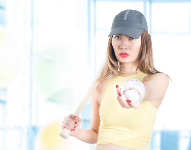 istock Female Baseball Player with baseball bat 1058468704