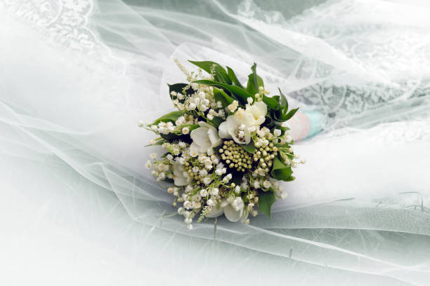 istock Wedding bouquet on a background of a veil 1058472268