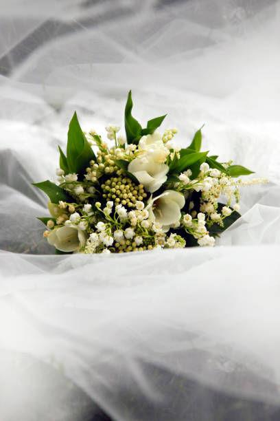 istock Wedding bouquet on a background of a veil 1058472340