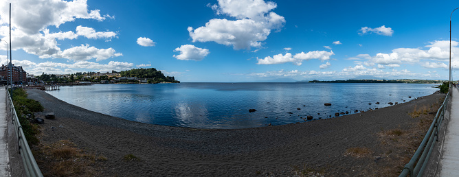 Panoramic landscape of the shore of Llanquihue lake in Puerto Varas with part of the village at the left side