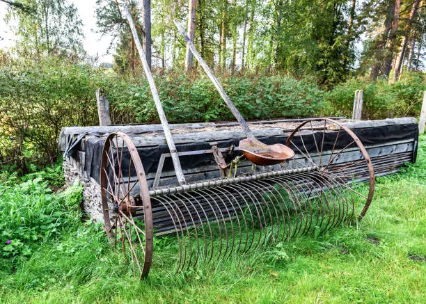 Photo of Obsolete model Hay Rake. Rusted old farm machinery