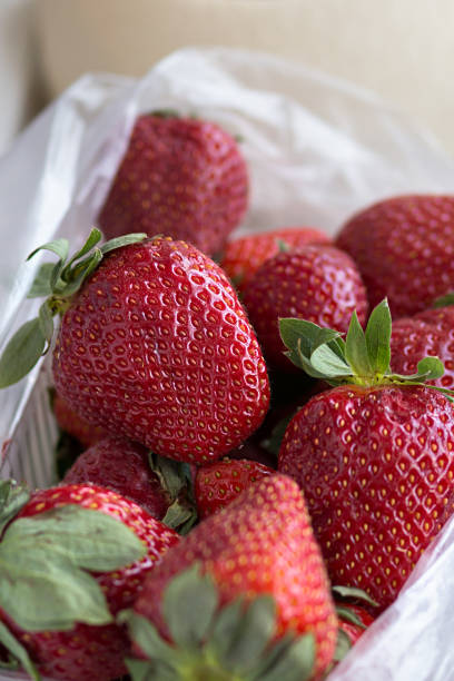 istock fresh ripe useful fruit strawberry in tray closeup 1058479392
