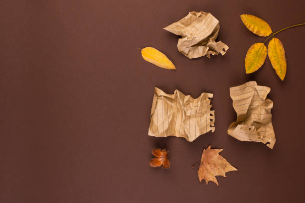 Notepad and crumpled sheets for writing, difficult work to write a letter. Free space for text. Autumn atmosphere and yellow leaves. Top view. Copy space. Notepad and crumpled sheets for writing, difficult work to write a letter. Free space for text. Autumn atmosphere and yellow leaves. Top view. Copy space unhappy poet stock pictures, royalty-free photos & images