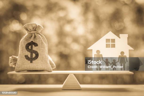 Legacy Inheritance Or Death Tax Concept Us Dollar Bag A House And Family Members Eg Father Mother Son Daughter On A Balance Scale Depicts A Tax Paid By Person Who Inherits Money Or Property Stock Photo - Download Image Now