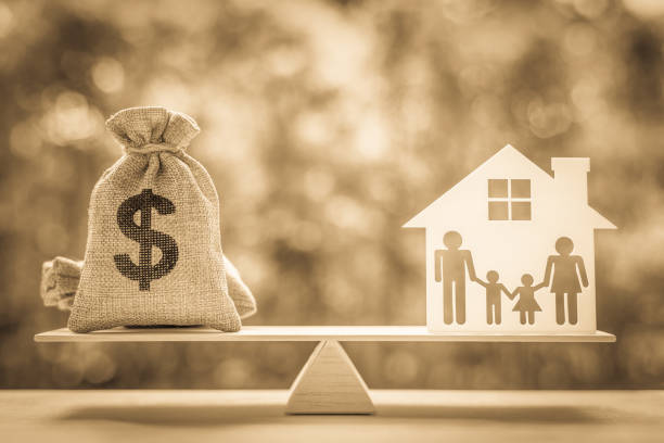 legacy / inheritance or death tax concept : us dollar bag, a house and family members e.g father, mother, son, daughter on a balance scale, depicts a tax paid by person who inherits money or property. - burlap sack fotos imagens e fotografias de stock