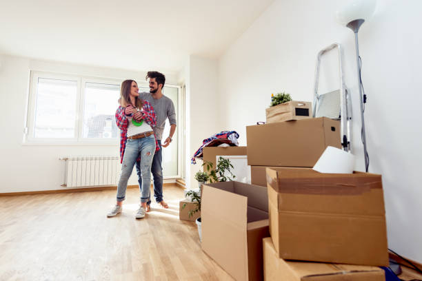 istock Young couple unpacking and cleaning in new empty apartment 1058481484