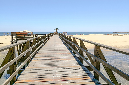 Isla Cristina beach and wood bridge in Costa de la Luz, Huelva, Spain in front Punta del Moral village, near beaches of Ayamonte.