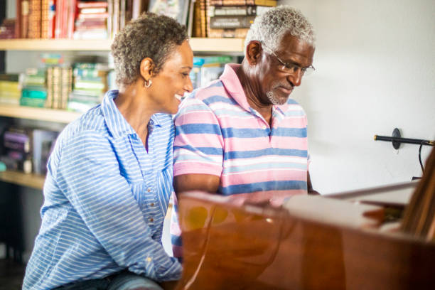 Senior Black Man Playing Piano with his Wife
