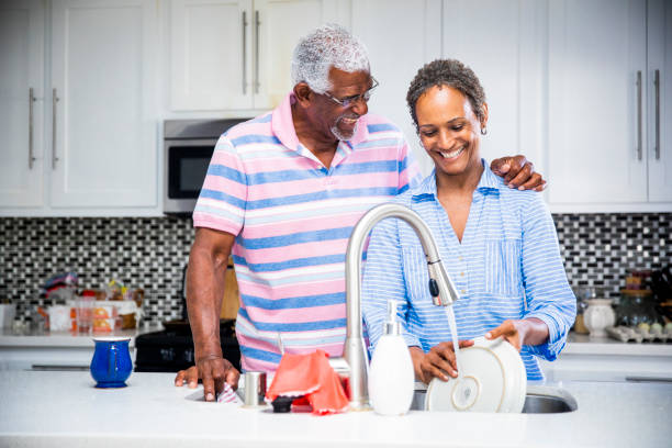 istock Senior Black Couple Doing the Dishes 1058486836