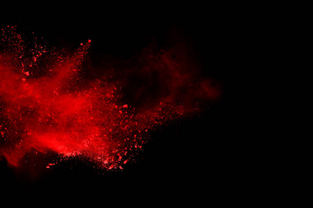 istock abstract red powder explosion on black background.abstract red powder splatted on black background. Freeze motion of red powder exploding. 1058487126