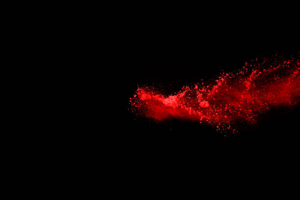 istock abstract red powder explosion on black background.abstract red powder splatted on black background. Freeze motion of red powder exploding. 1058487154