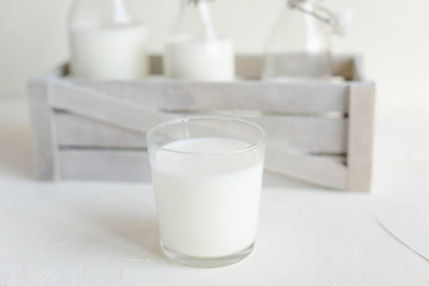 istock Milk in bottles on white background, kitchen 1058496898