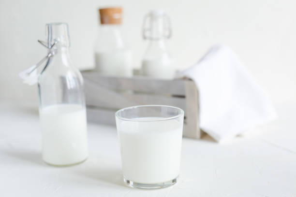 istock Milk in bottles on white background, kitchen 1058497720