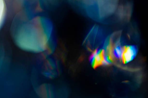 Colorful soft circular bokeh overlay for use to enhance images with copy space on a deep twilight blue background