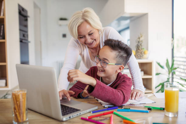 istock Mother and son doing homework at home 1058505406