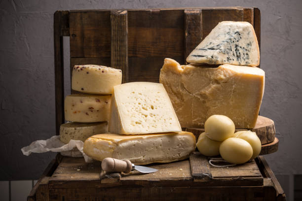 Parmesan, taleggio, caciotta and asolo cheese on dark wooden table stock photo