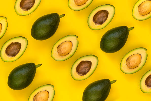 istock Avocado on the yellow background. Top view 1058508112