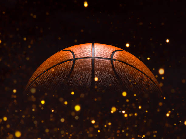 Basketball close-up on studio background - Stock image Basketball close-up on black background with bokeh, spotlights sports court photos stock pictures, royalty-free photos & images