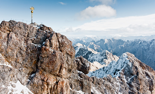 Sign on the top of Zugspitze mountain. Famous landmark in Bavaria. The highest mountain in Germany. Clear sunny day in highlands of the Alps. Snow peaks of the mountains.