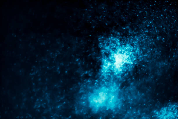 istock Abstract bokeh glitter background. Defocused background. Blurred bright light on black 1058510840