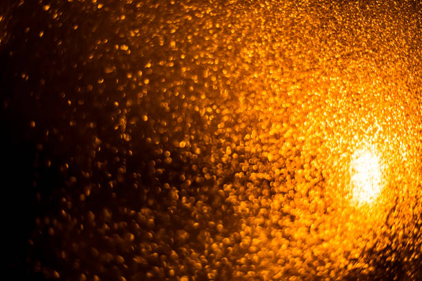 istock Abstract bokeh glitter background. Defocused background. Blurred bright light on black 1058511426