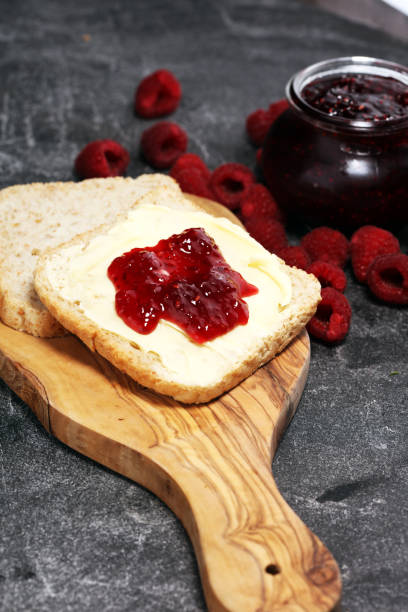istock Toast bread with homemade raspberry jam or marmalade on rustic table served with butter for breakfast or brunch 1058514404