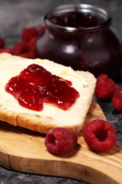 istock Toast bread with homemade raspberry jam or marmalade on rustic table served with butter for breakfast or brunch 1058516596