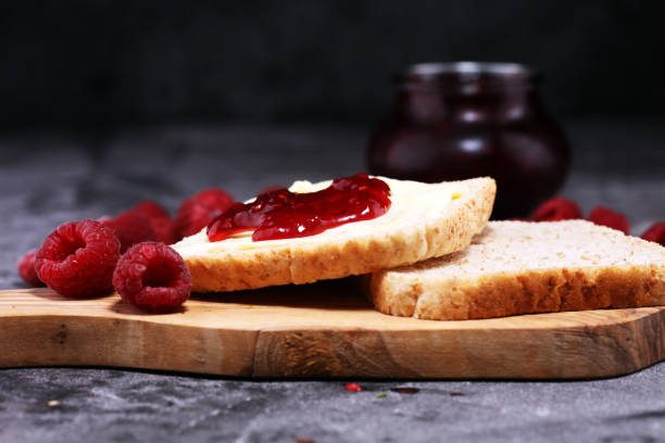 istock Toast bread with homemade raspberry jam or marmalade on rustic table served with butter for breakfast or brunch 1058516718